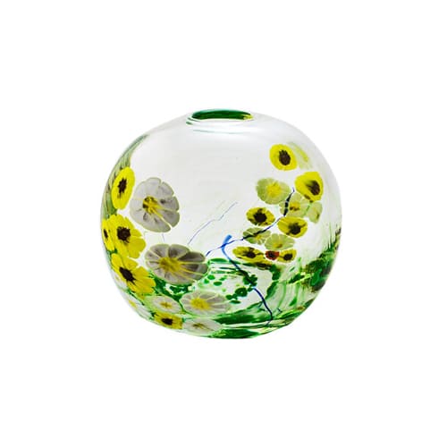 Clear circular vase with yellow daisies and green stems