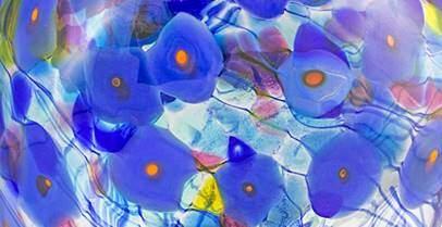 Close up of blue poppies on glass piece